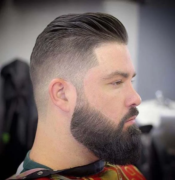 Slicked-back cut with a full beard